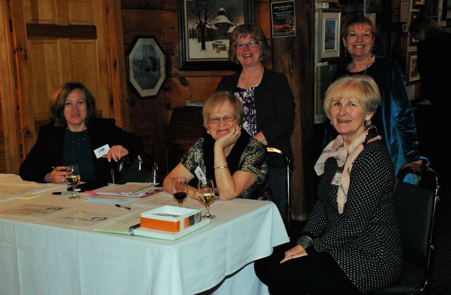 Welcoming Table (standing: Teresa Gillis, Pam Duncan; sitting: Sueda Akkor, Audrey Parker, Nedine Moore)